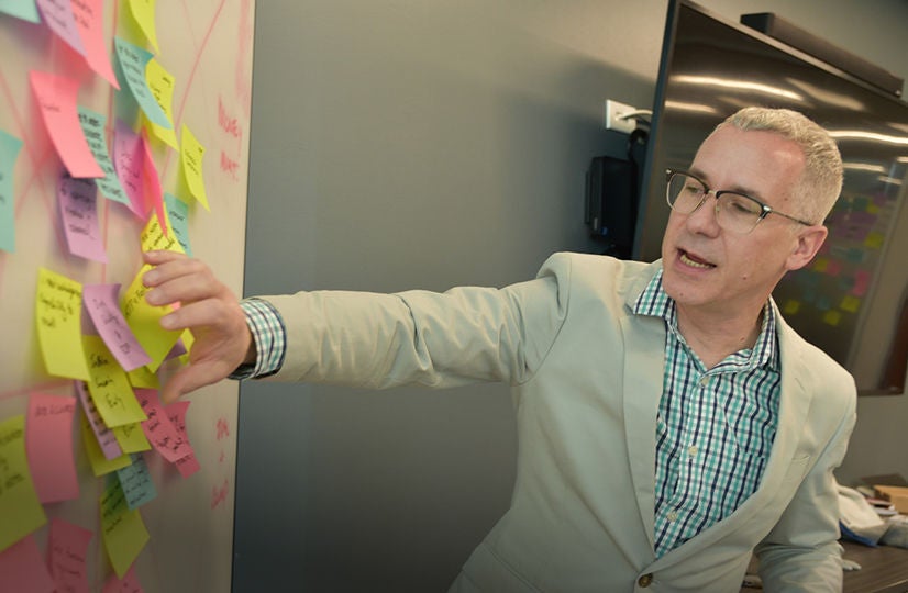 Man discussing corporate governance with colleagues.