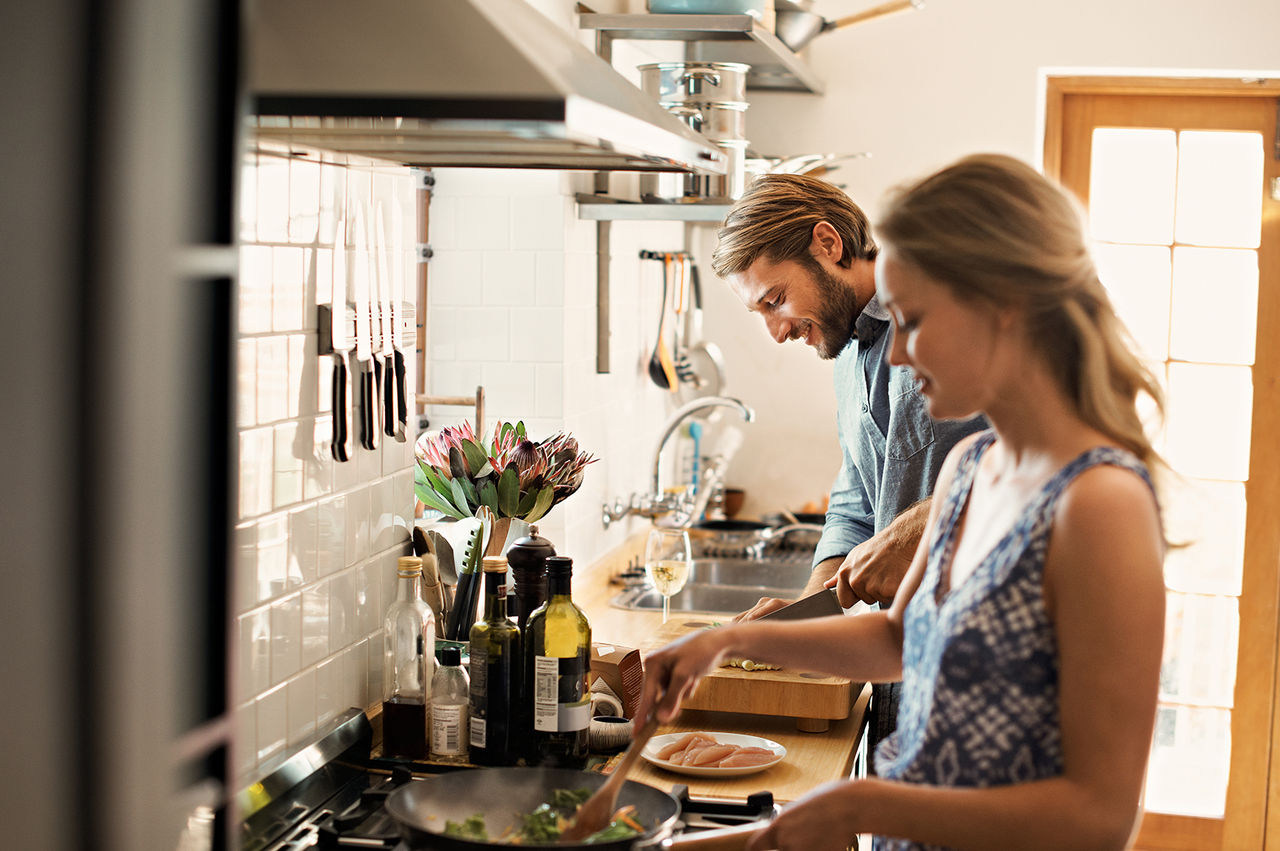 Couple cooking dinner together. 