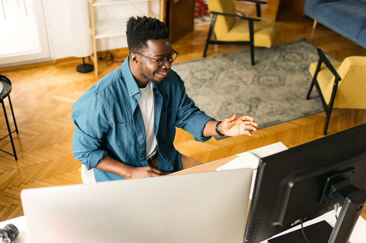 Smiling man working remotely from his home office. 