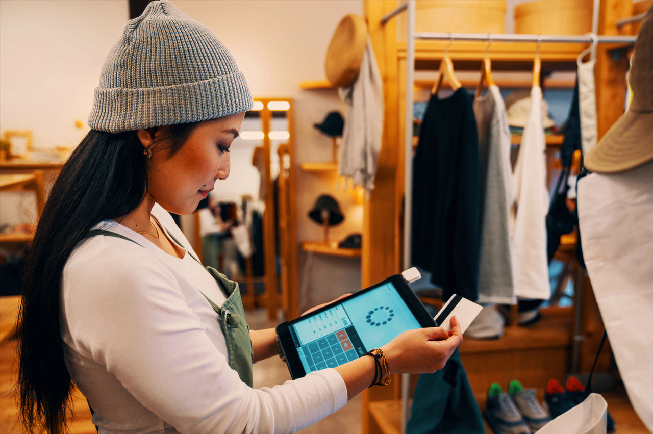 Clothing retailer using a tablet-based POS system to process a card payment. 