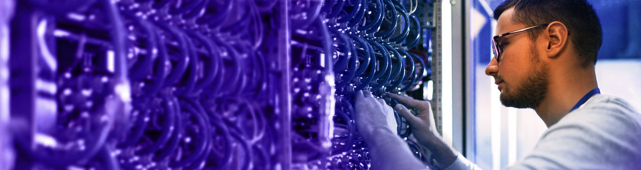 Man inspecting a server rack. 