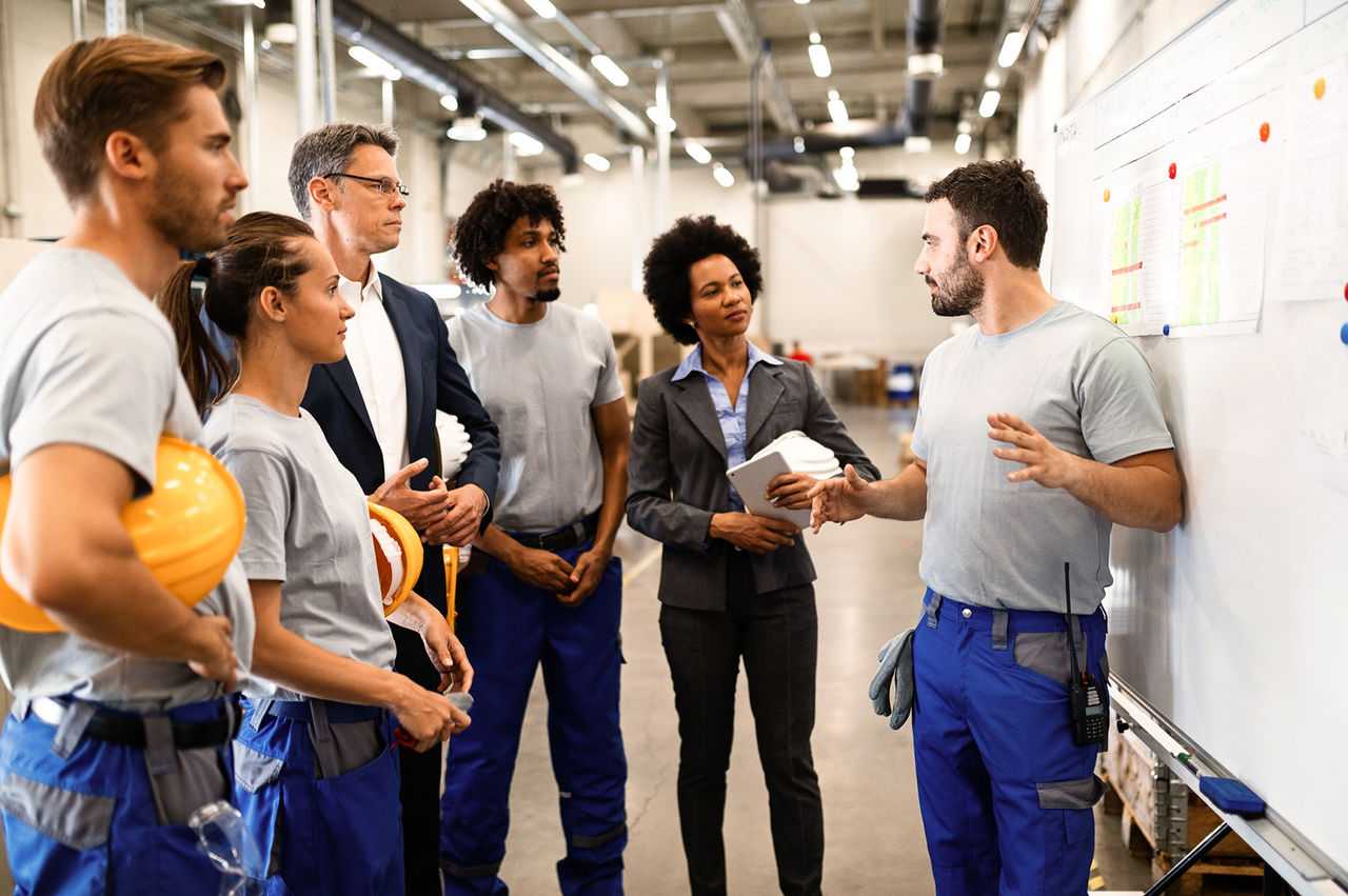 Warehouse team discussing inventory.